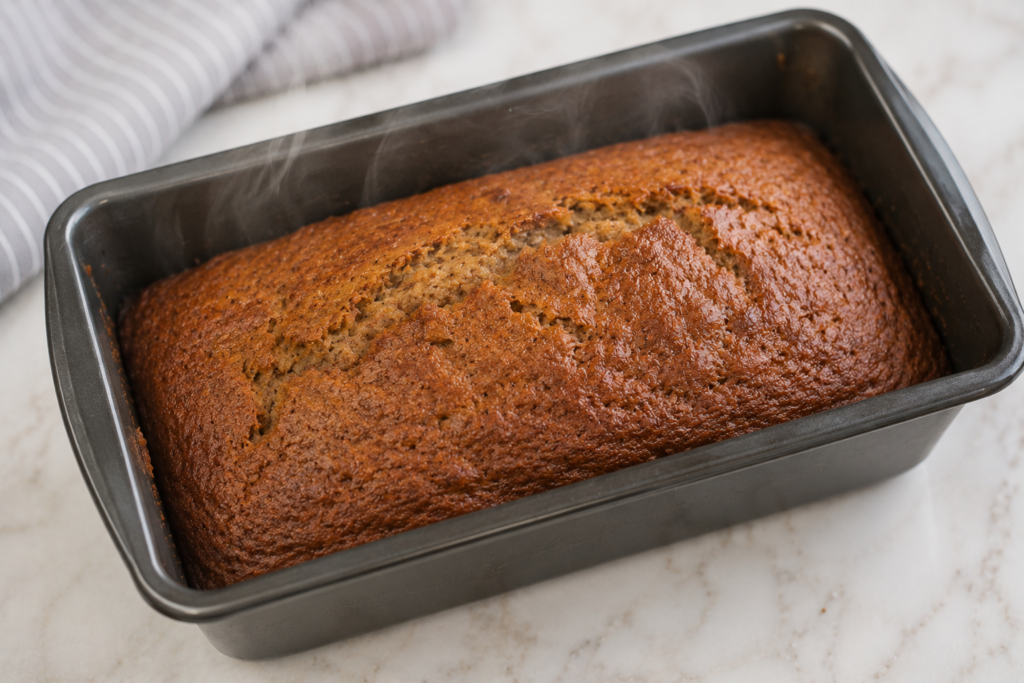 Freshly baked moist gluten free banana bread cooling on a wire rack