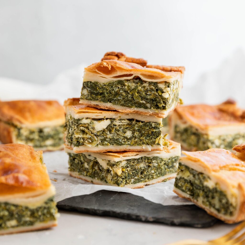 Freshly baked gluten free spinach and cheese pie with a flaky golden crust and creamy savory filling.